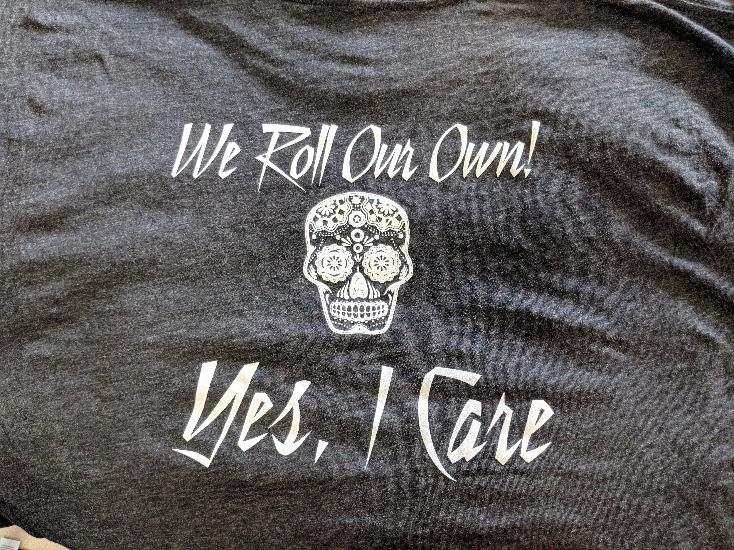 Custom screen printed restaurant uniform shirts reading We Roll Our Own produced for Taco Joint in Austin, TX.