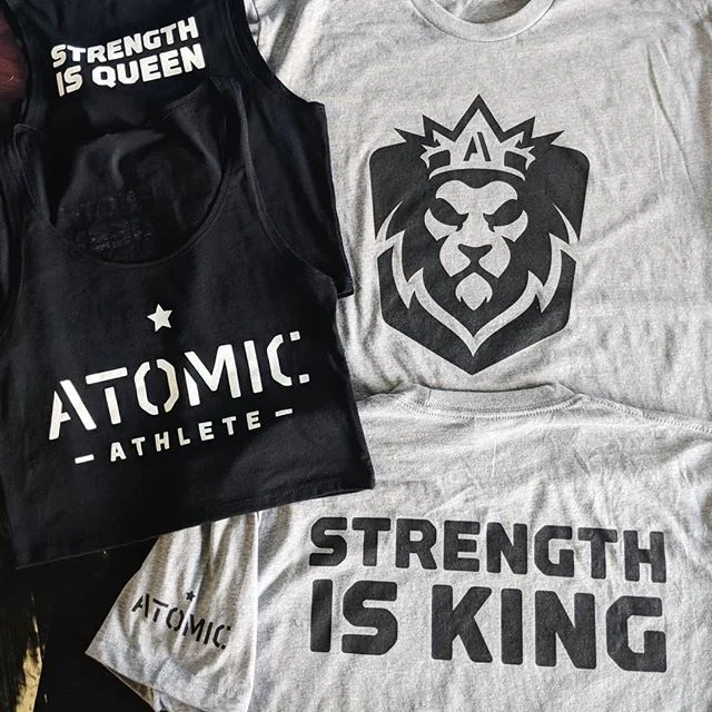 Custom screen printed athletic tank tops featuring the lion crest for Atomic Athlete.