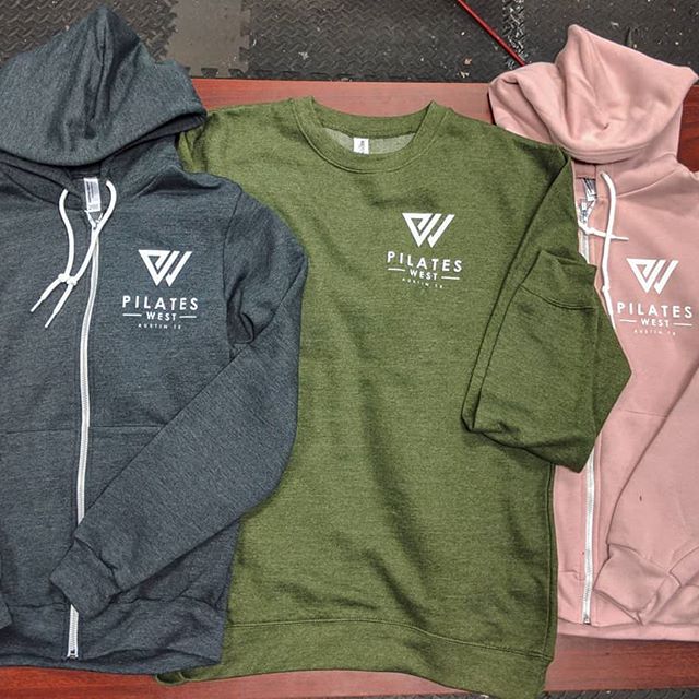 Custom branded fitness outerwear and zip-up hoodies printed with stretch inks for Pilates West.