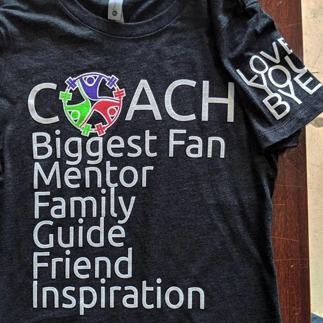 Custom screen printed staff shirts and organizational apparel produced for a Texas team.