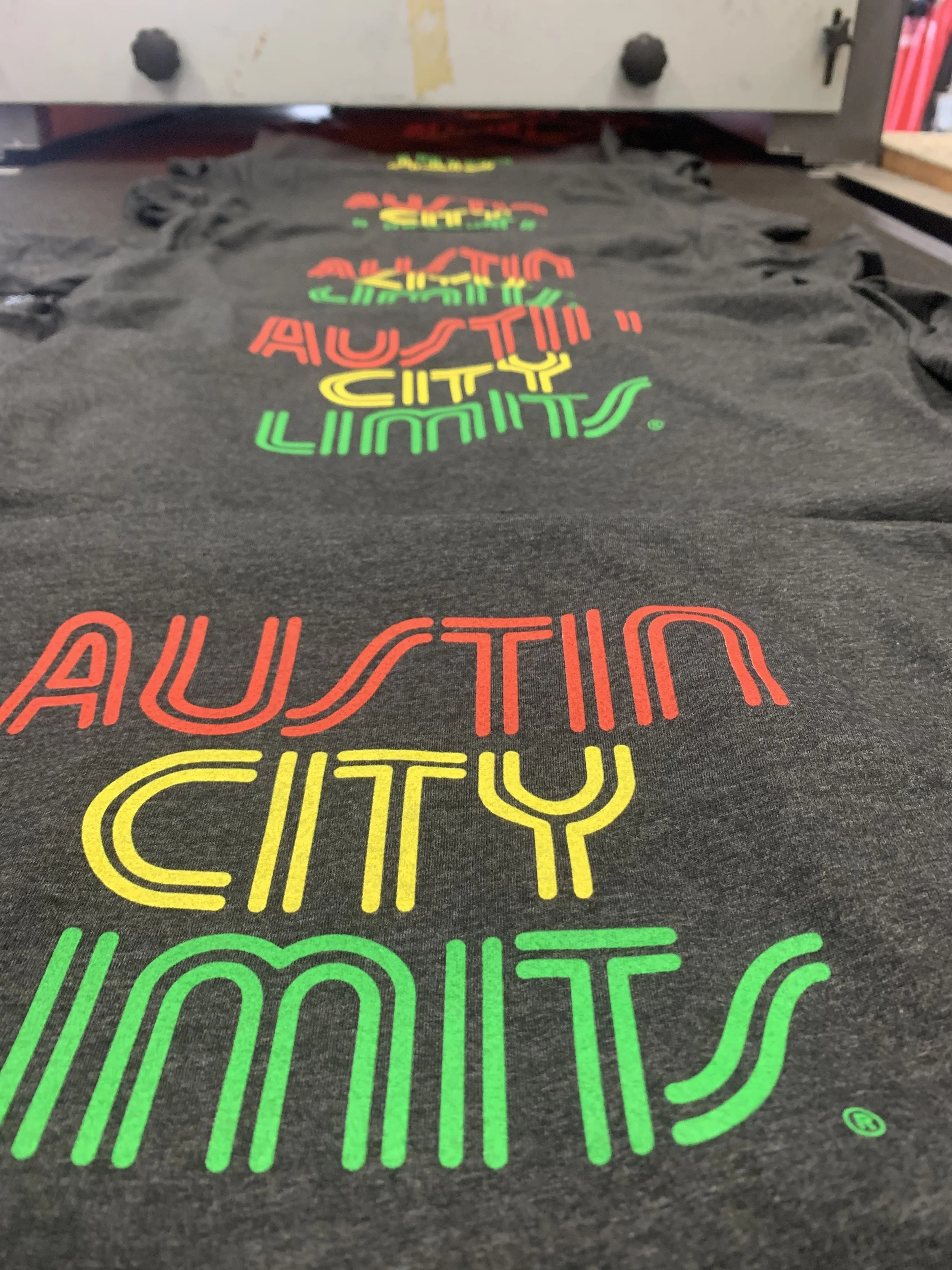 Custom plastisol screen printed t-shirts with vibrant multi-color logo