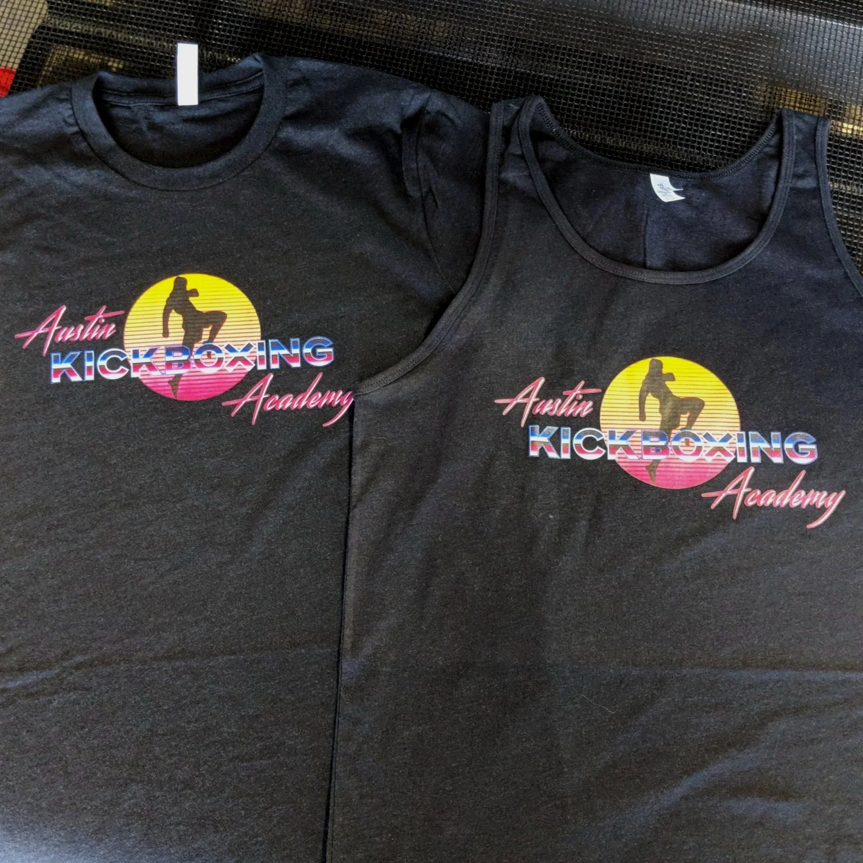 Custom screen printed moisture-wicking athletic tank tops manufactured for Austin Kickboxing Academy.