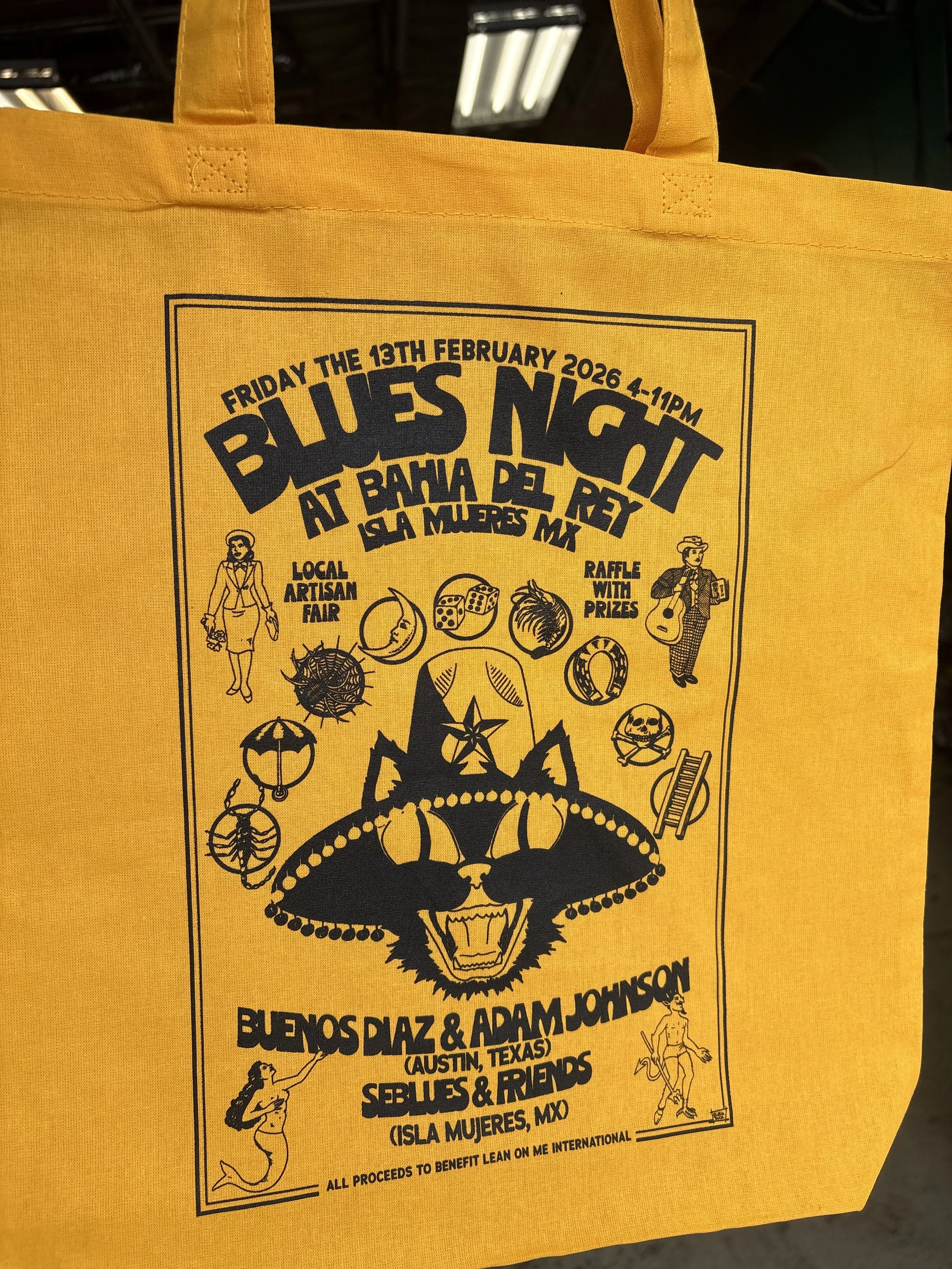 Yellow tote bag with "Blues Night at Bahia Del Rey" and a cat head illustration