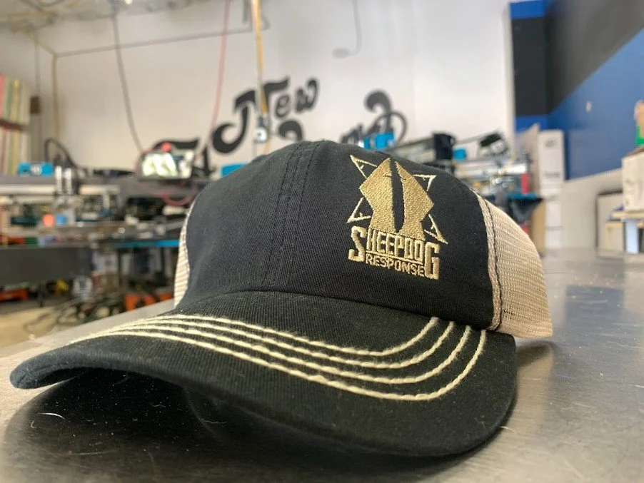 Company branded embroidered trucker hats manufactured for Sheepdog Response in Austin, TX.