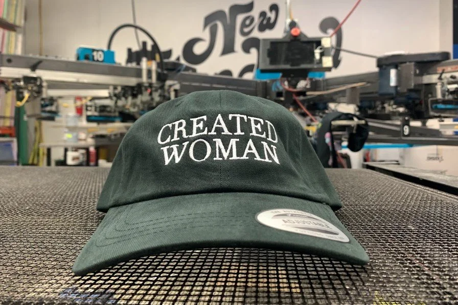 Custom embroidered promotional company hats produced for Created Woman in Austin.