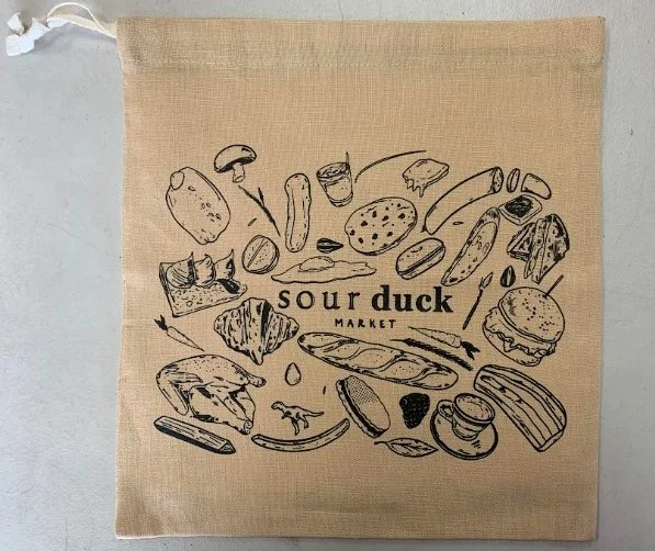 Custom screen printed reusable produce bags manufactured for Sour Duck Market in Austin, TX.
