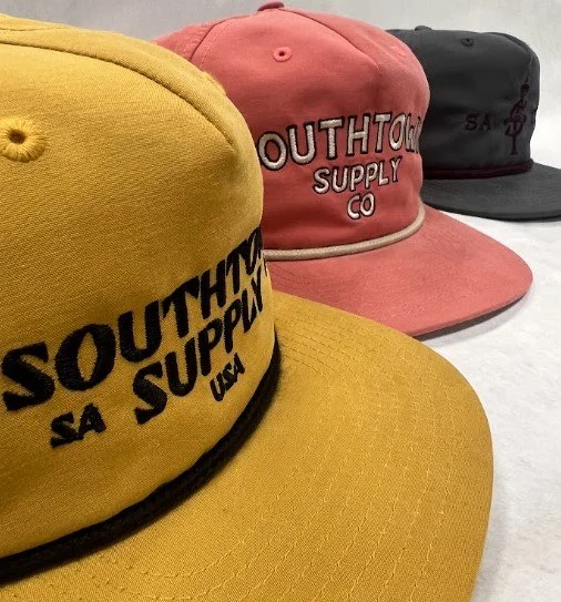 Bulk custom embroidered snapback hats manufactured for Southtown Supply Co.