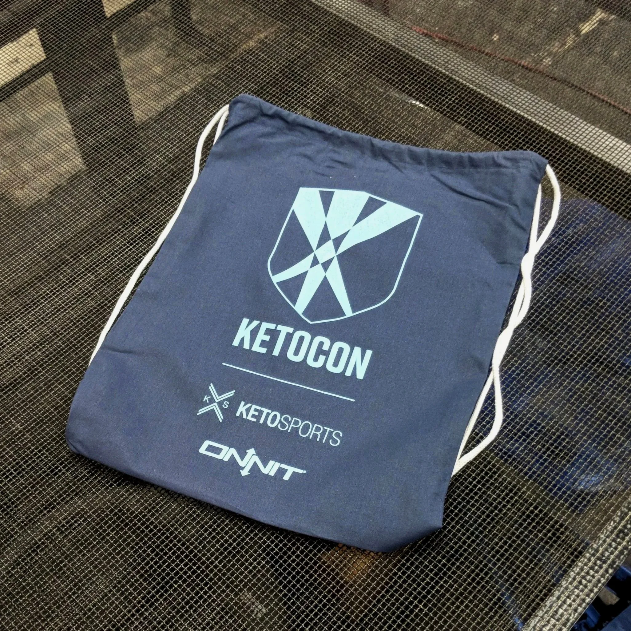 Custom promotional drawstring bags screen printed for KetoCon and Onnit in Texas.