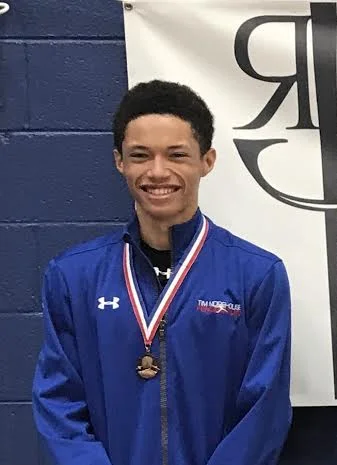 Pictured: Nathan Andrews wears his Top-8 Medal in Junior Men’s Foil