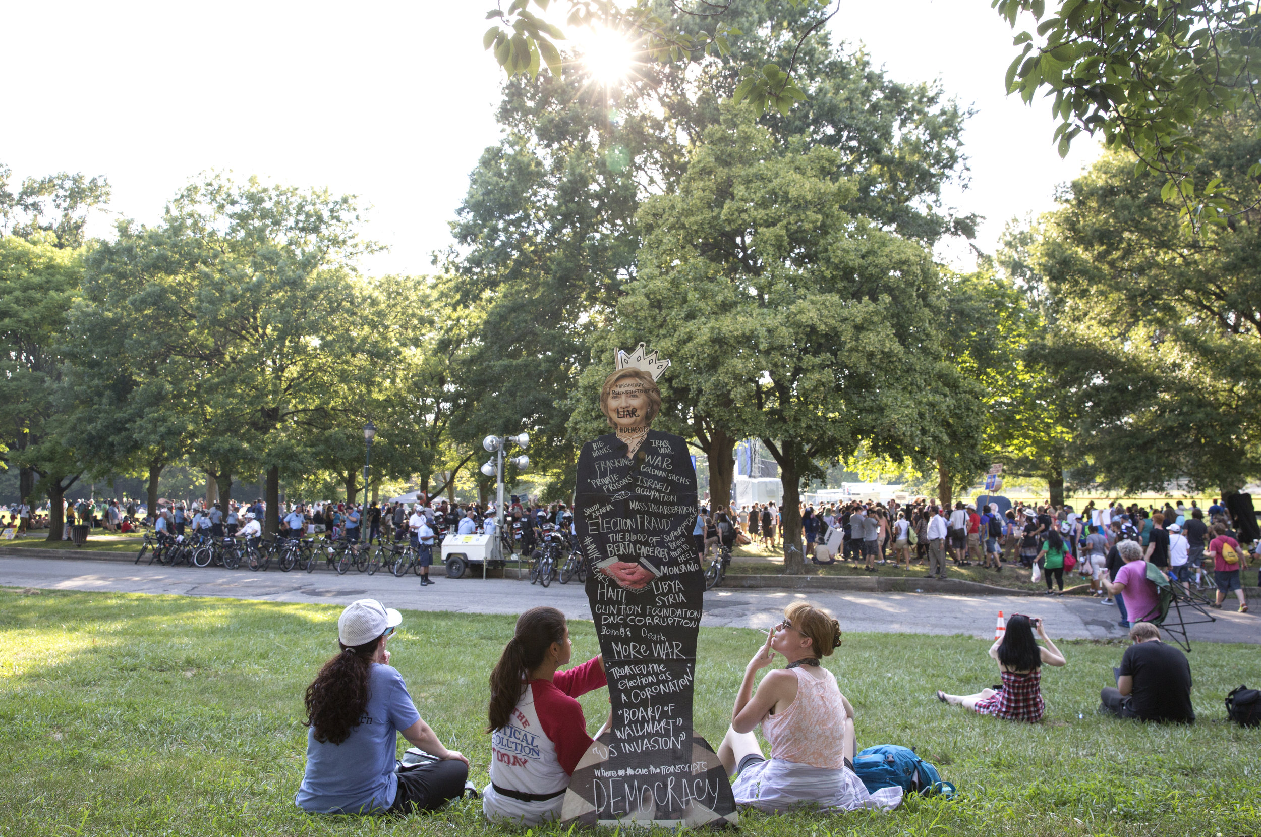  Bernie Sanders supporters hold up a Hillary Clinton cutout while sitting on the grass during the Democratic National Convention in Philadelphia on Tuesday, July 26, 2016.&nbsp; 