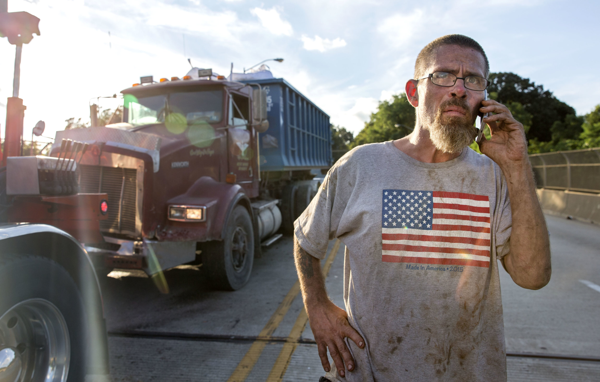  Frank Beale, of Weston, W.Va., explains the situation with his boss after crashing into his lead man’s truck on Tuesday, July 25, 2017 near the McKees Rocks Bridge. Beale was traveling from Aliquippa when he lost control of his truck. “Coming down t