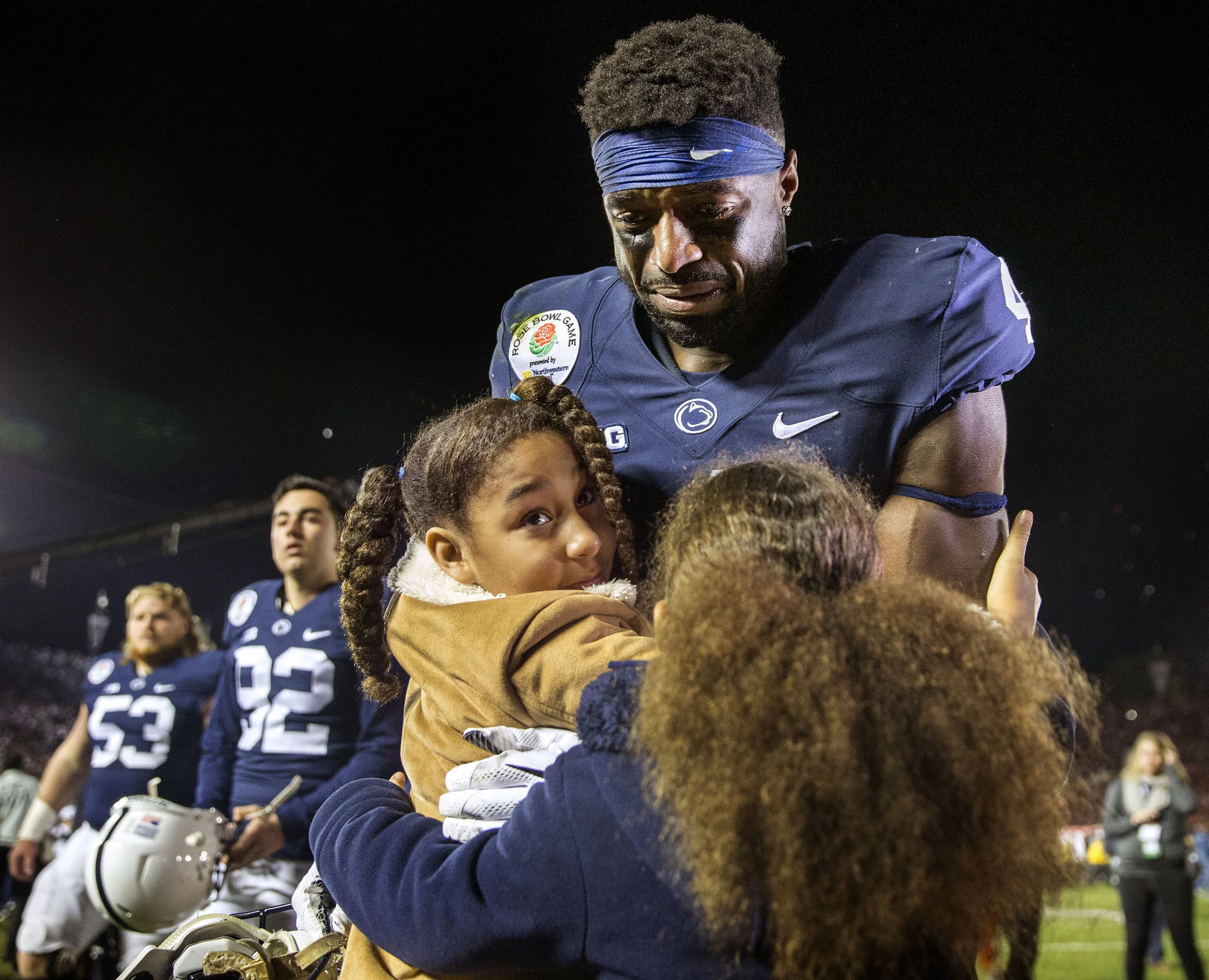 Addy and Shola Franklin hug Penn State's Nick Scott after USC defeated the Nittany Lions 52-49 in the Rose Bowl game in Pasadena, CA on Monday, Jan. 2, 2017.