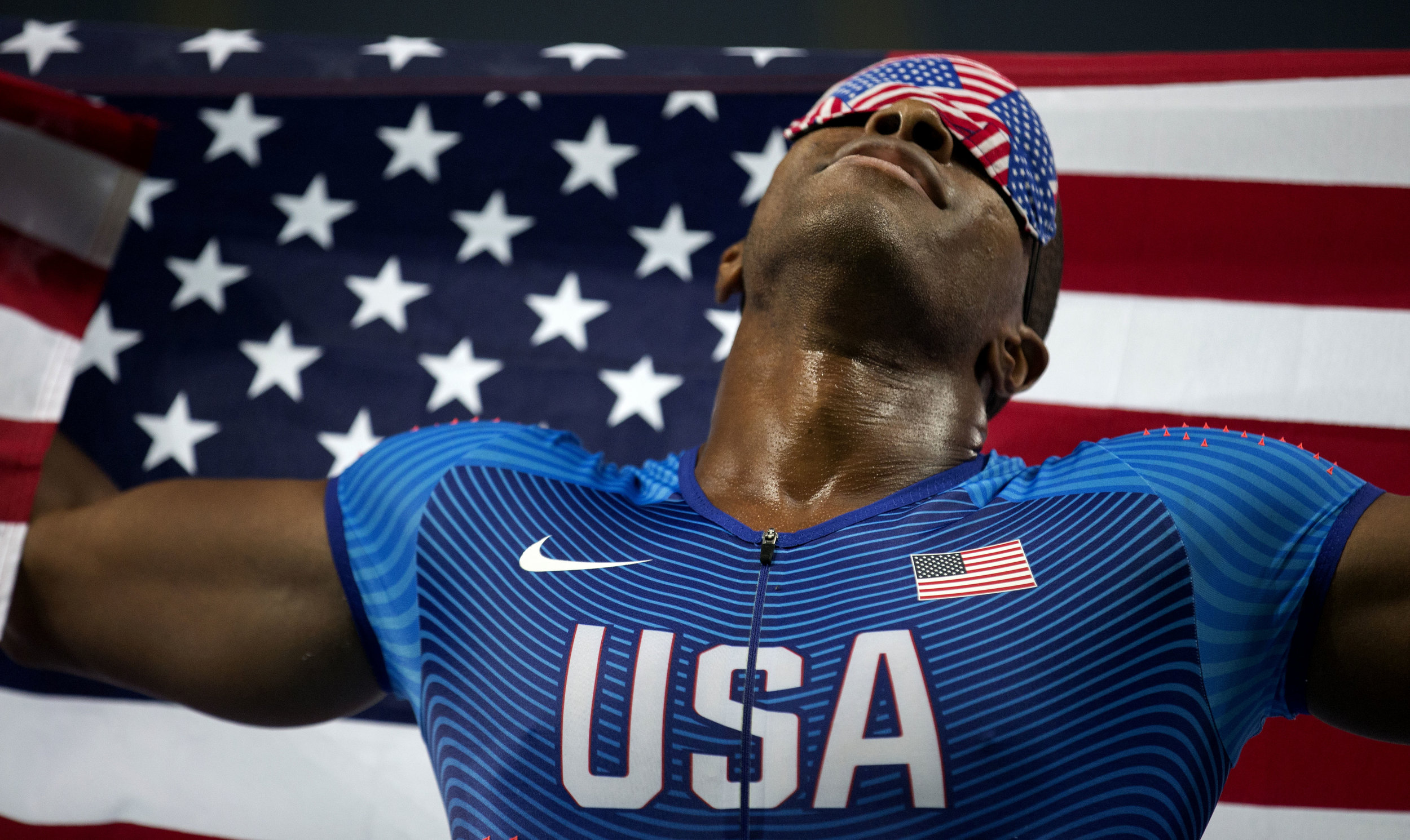  David Brown holds an American flag aloft as he and his sighted guide, Jerome Avery, celebrate Brown’s Paralymic record time of 10.99 seconds in the 100 meter dash at the 2016 Paralympic Games at Olympic Stadium in Rio de Janeiro, on Sunday, Sept. 11