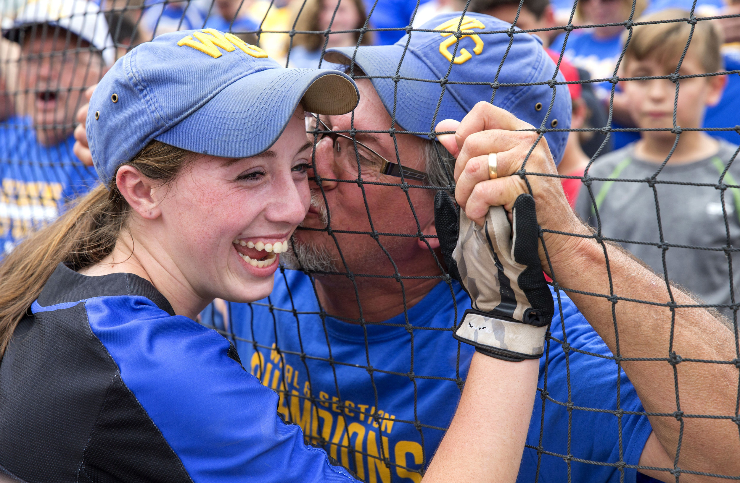  John Lampe, of West Greene, kisses his daughters cheek, Madison Lampe (4), after her team came back to win the state championship at Beard Field on Friday, June 16, 2017. West Greene was down 7-0 in the 2nd inning but rallied together to defeat Will