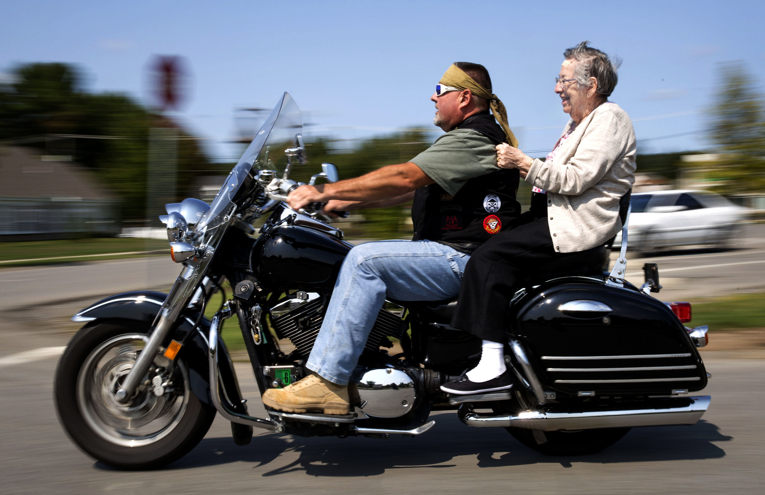 Irene Morar grips the back of Michael Kopera’s, of Evan City, leather vest while riding on a motorcycle on Sunday, Sept. 10, 2017 at the Lutheran Senior Life Passavant Community in Zelienople. Caretakers at the Lutheran Senior Life Passavant Community wanted to fulfill Alvin Graf’s, 98 years old, wish of riding a motorcycle after not having ridden one since WWII. The American Legion Riders offered their help and came out to not only grant Graf’s wish, but also other senior residents who got the opportunity to go out on a joyride. 