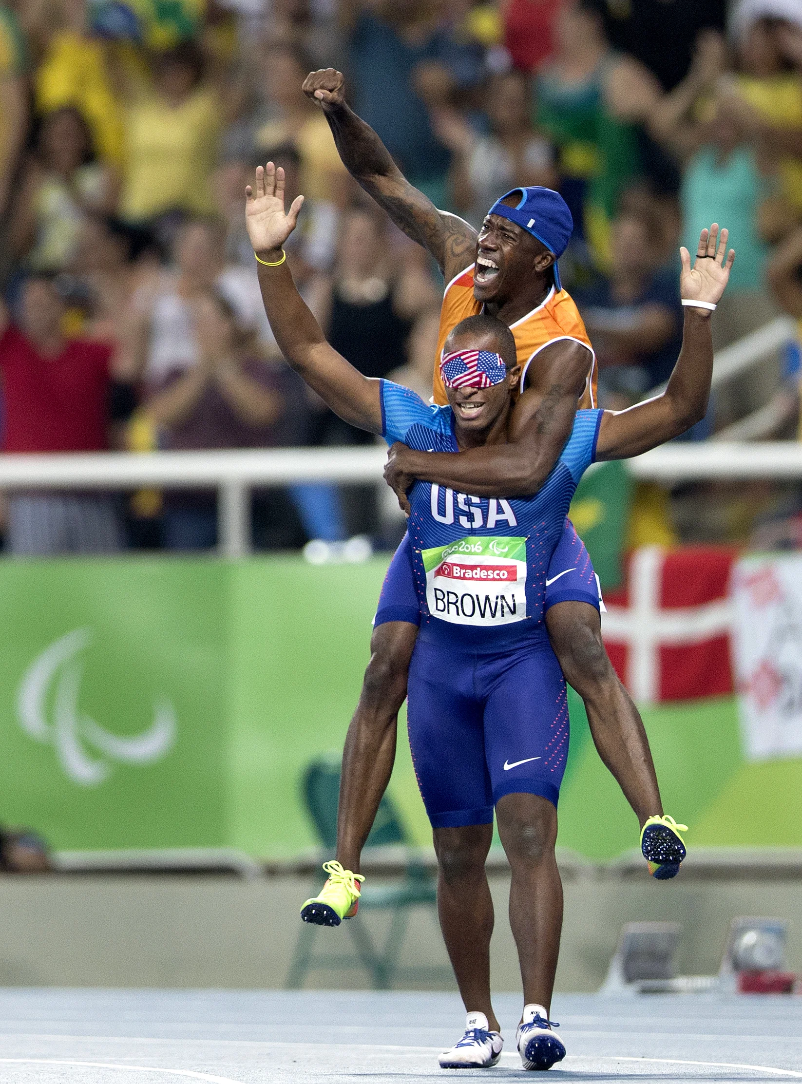 Jerome Avery, David Brown’s guide, jumps ontop of Brown’s back and celebrate Brown’s Paralymic record time of 10.99 seconds in the 100 meter dash at the 2016 Paralympic Games at Olympic Stadium in Rio de Janeiro, on Sunday, Sept. 11, 2016.