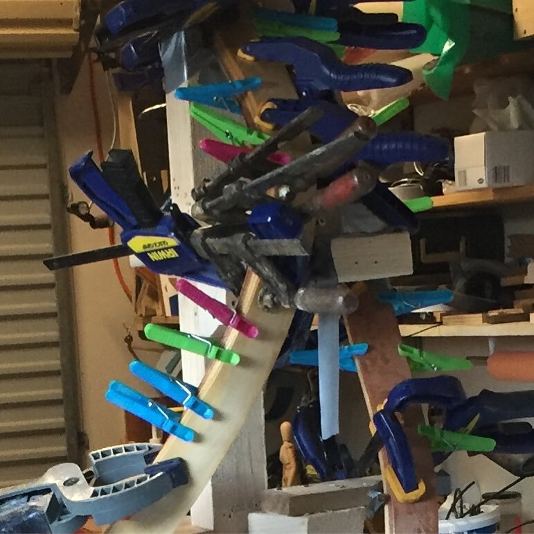 When you run short of clamps raid the washing line! Pegs make great clamps when laminating timber veneers into compound curves as I am doing here making the mould for my sculpture Mr Percival which has been selected for entry in the Kingaroy Biennial