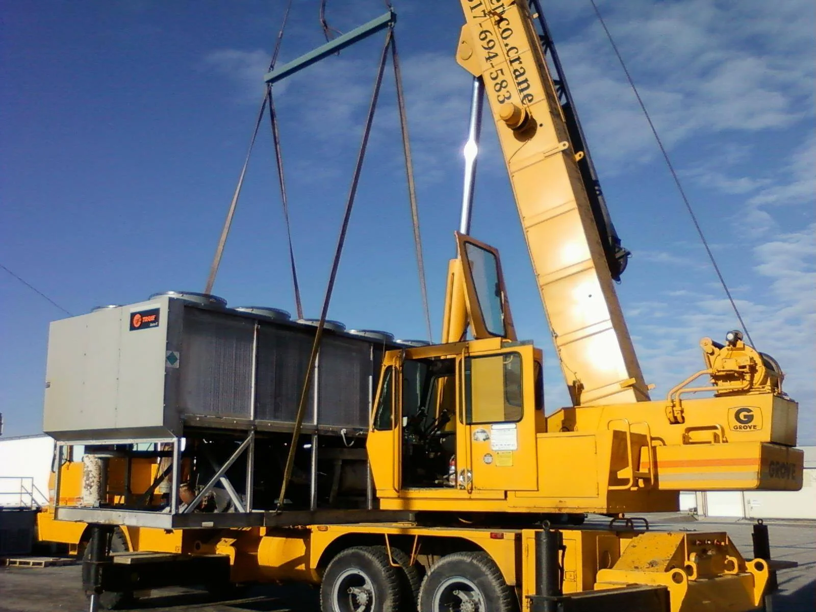 KnepCo Crane Services moving large tanks in Columbus, IN.
