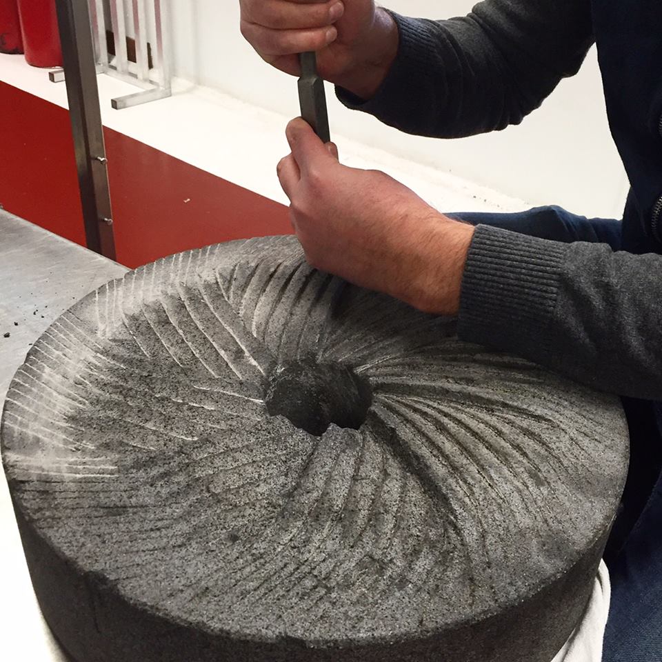 Tobe hand carving the volcanic grinding stones 