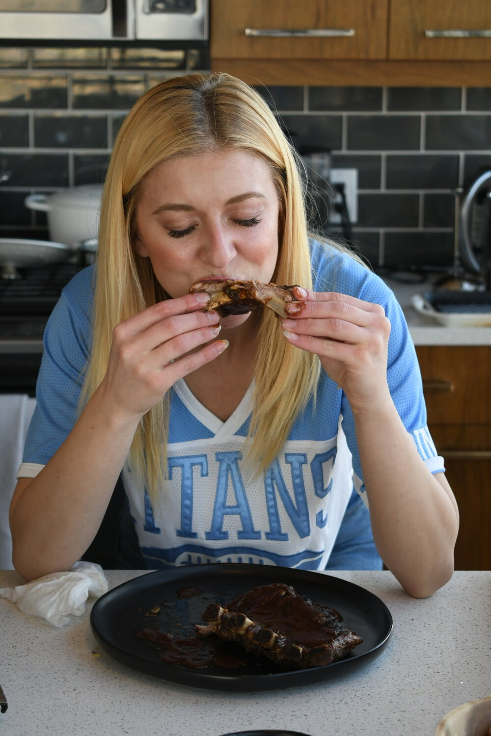Amber Strohauer eating ribs_Fairy Gutmother Carley Smith_Strohauer Farms_Super Bowl Guide.JPG