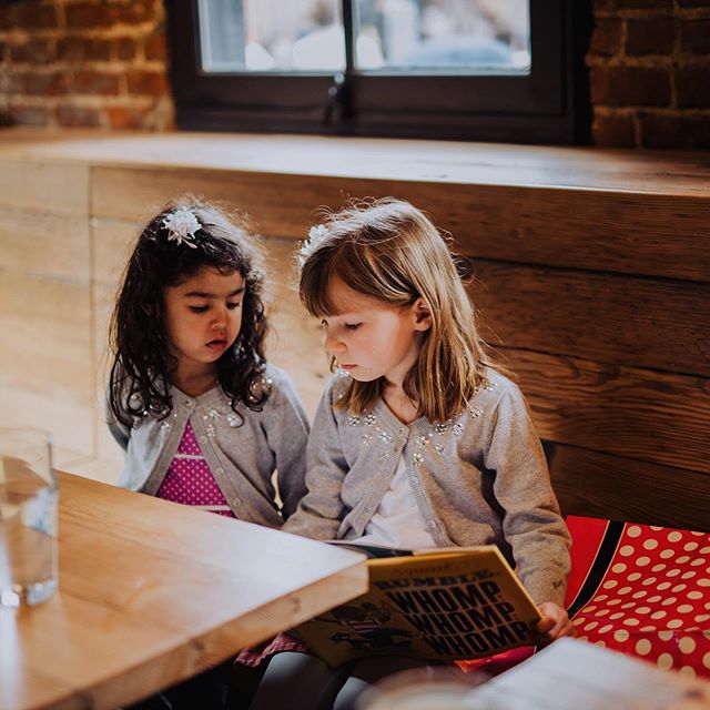 rehearsal dinners are far less boring when you have an older cousin who can read to you. | both girls are in @loveauntmaggie creations: maya is in a #librarydress and etta is in the #swingsetskirt both from @oliverands | 📸 @ryansinphoto #theredwoodw
