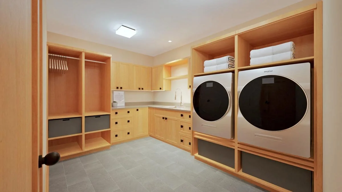  Rendering of a basement laundry room with maple cabinetry, raised front-load washer and dryer, a utility sink and open cubbies with a hanging rod. 