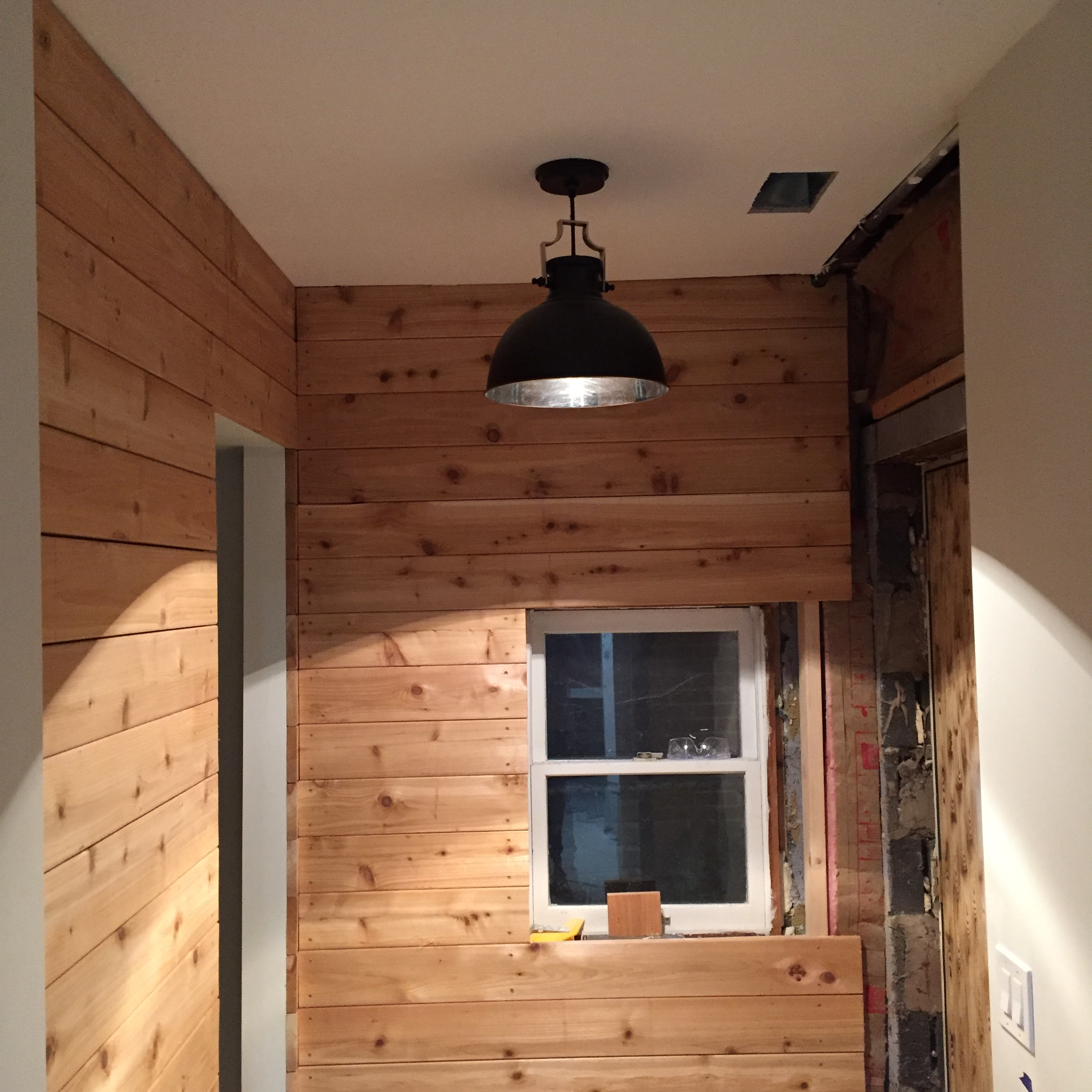 Pendant at the front entry. There's more of that raw cedar.