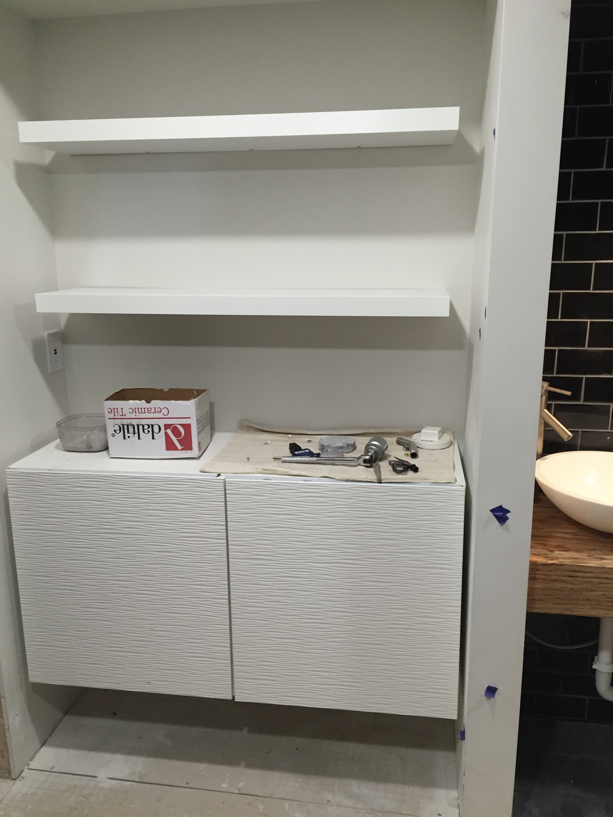 Storage in the first floor bath, which will also be the laundry room.