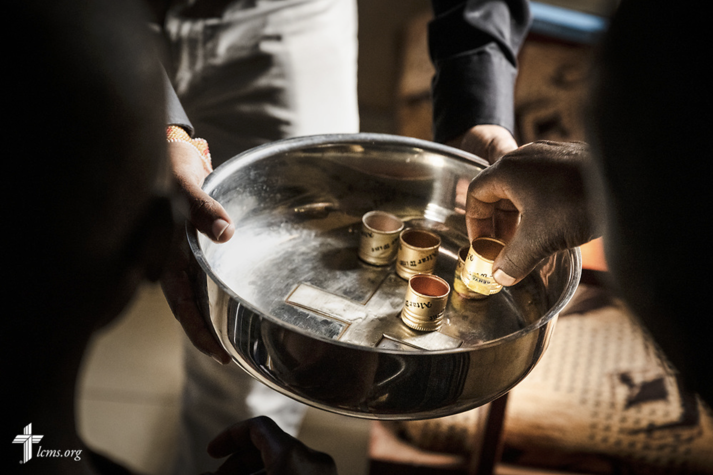   Christ's Care for Children: Kenya  Kelvin Lenaseyan, a student at nearby Matongo Lutheran Theological College, assists in the distribution, assists in the distribution of the Sacrament to young men of the Othoro ELCK (Evangelical Lutheran Church in