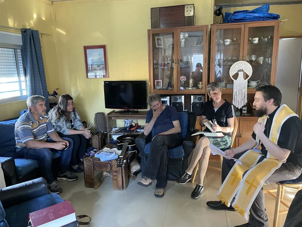 Pastor Phil leading Bible study and the service of the Word with the small group gathered in Nestor and Rita's home in Costa de Oro.