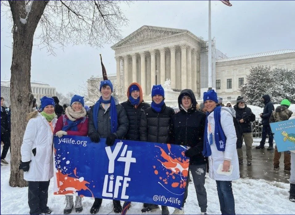  K. Gresh, T. Grimenstein, J. Bishop, L. Lemonovich, M. Gresh, J. Grimenstein, and S. Bishop in front of the U.S. Supreme Court at the end of the March. 