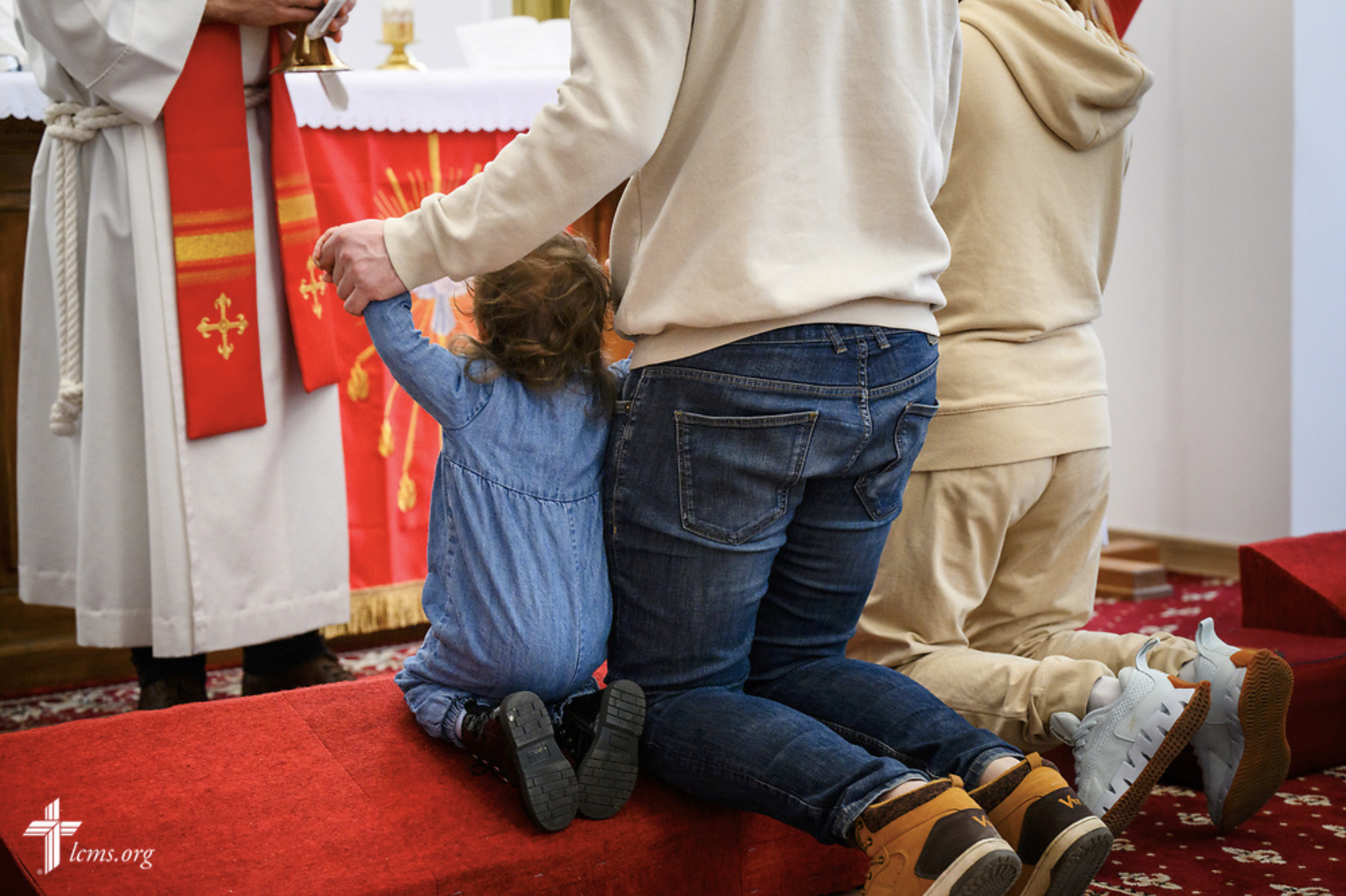  A family kneels during Divine Service at the Confessional Lutheran Church in Romania (Biserica Lutherană Confesională din România) St. Mary's Lutheran Center on Sunday, Feb. 18, 2024, in Brașov, Romania. LCMS Communications/Erik M. Lunsford 