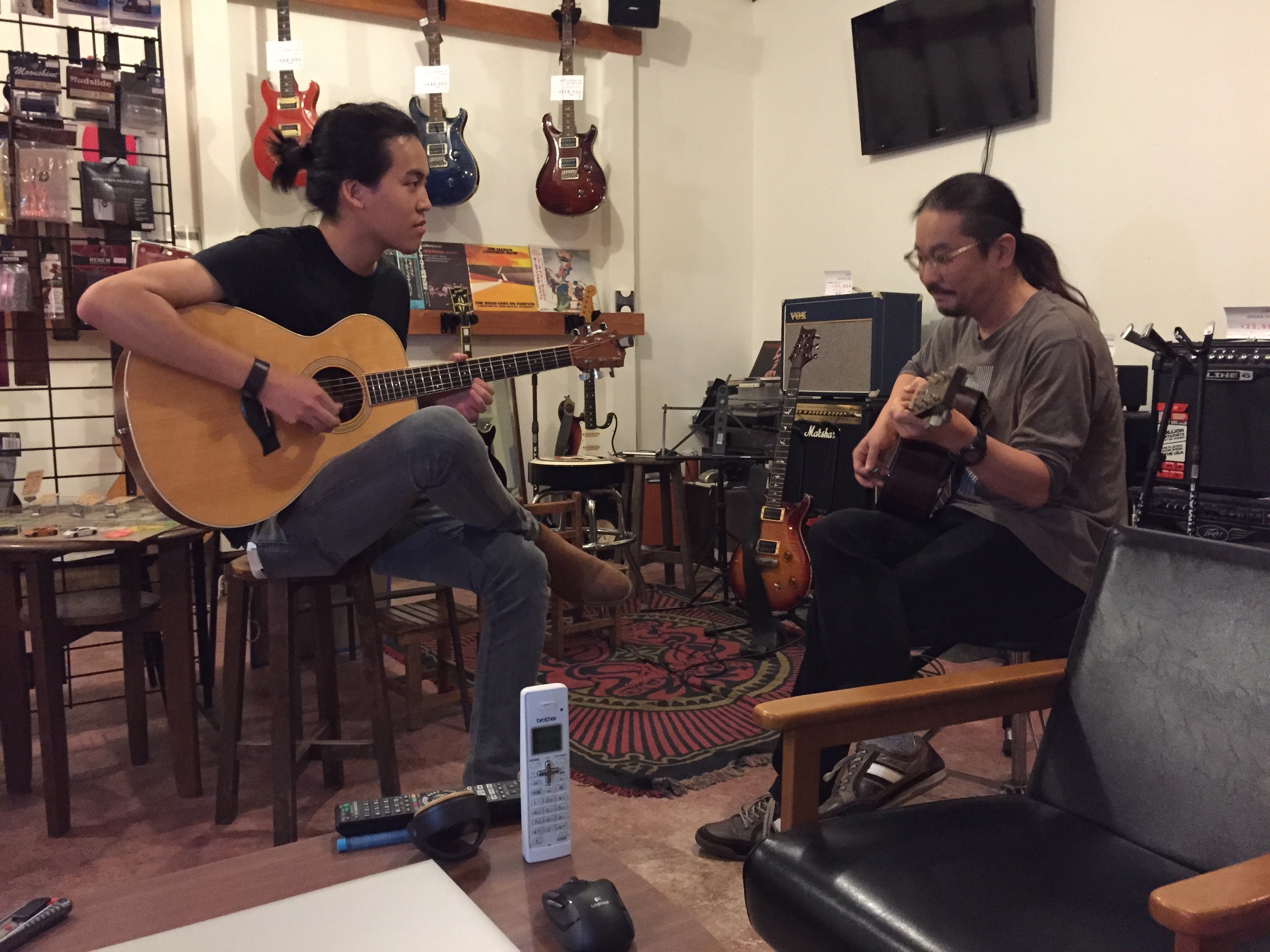 Jamming with a local guitar shop owner after a day of filming in Japan