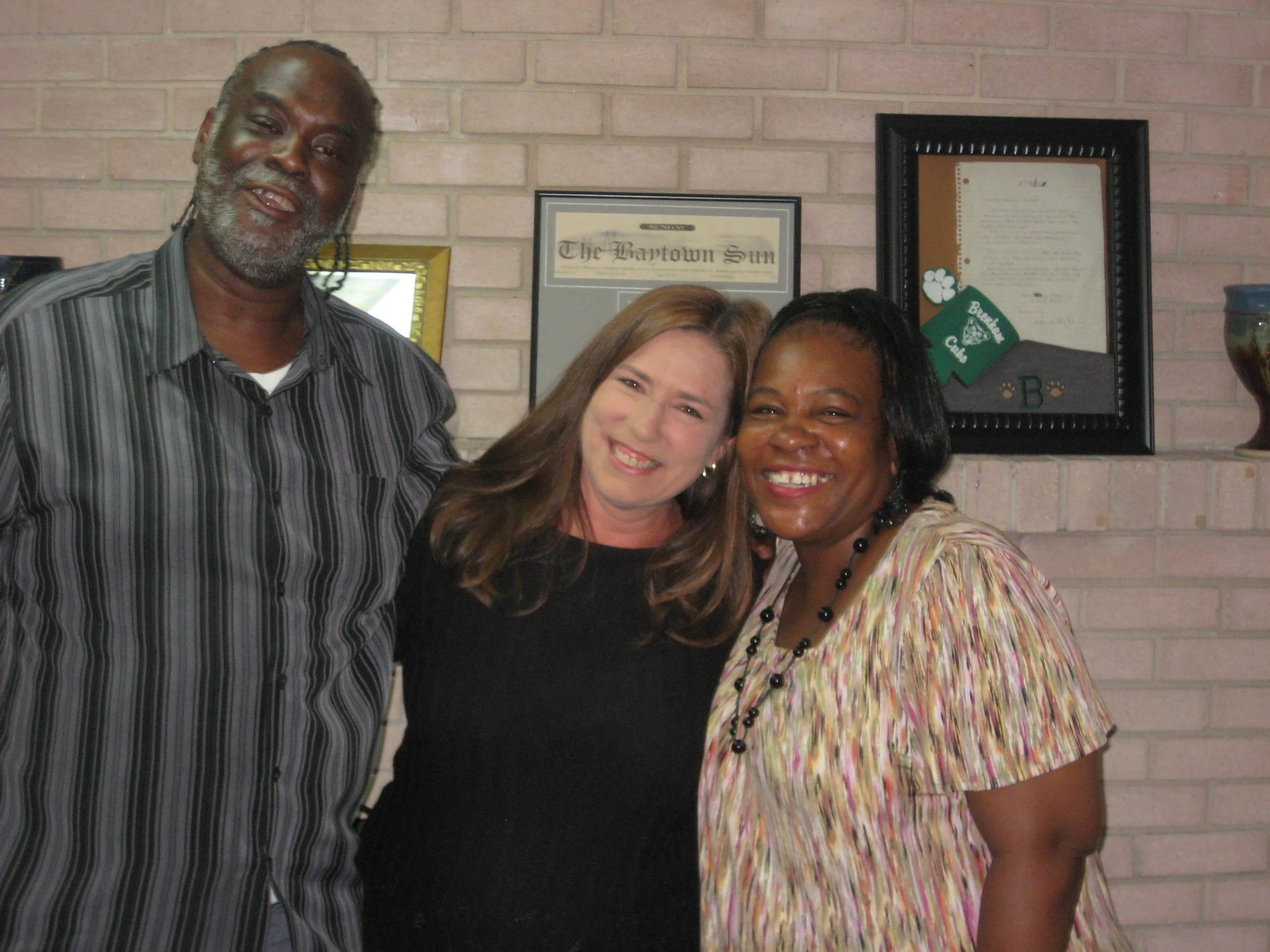 Pictured with clients Bobby and Andrea Robinson is legal assistant, Debra Davis, a Barbers Hill native. Debra has been with the Law Offices of Craig Muessig for the last 18 years and, "is loved by our clients," according to Muessig. 