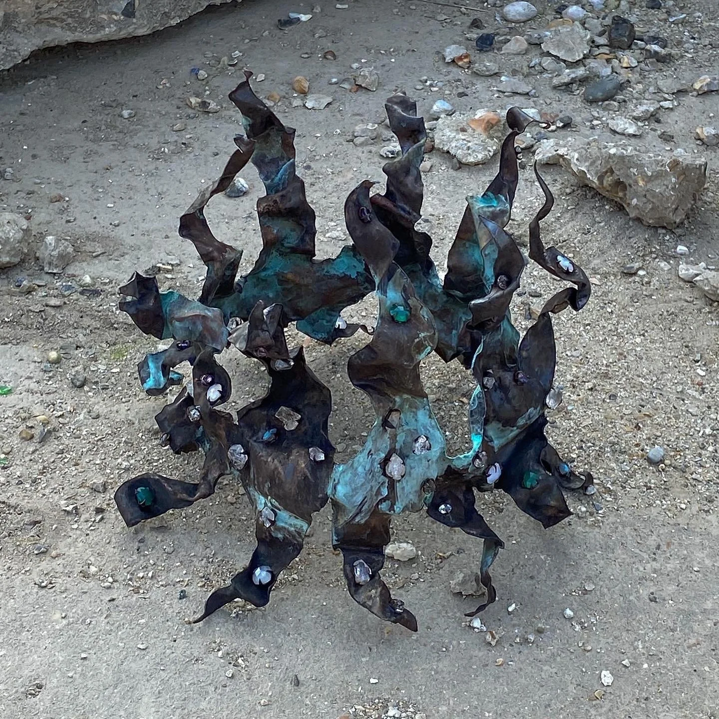   The Crown  (2022). Copper crown encrusted with sapphires, opals, amethysts, herkimer diamonds, moonstones, iolites, agates and labradorites. 25x22cm. 