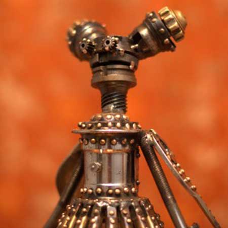 Maribelle, Mercury Class Astrobot: 19 drill taps, brass oxy-acetylene, miscellaneous bike parts, articulated grease port belly button, big bolt shoes, 22" x 12" x 7", sold