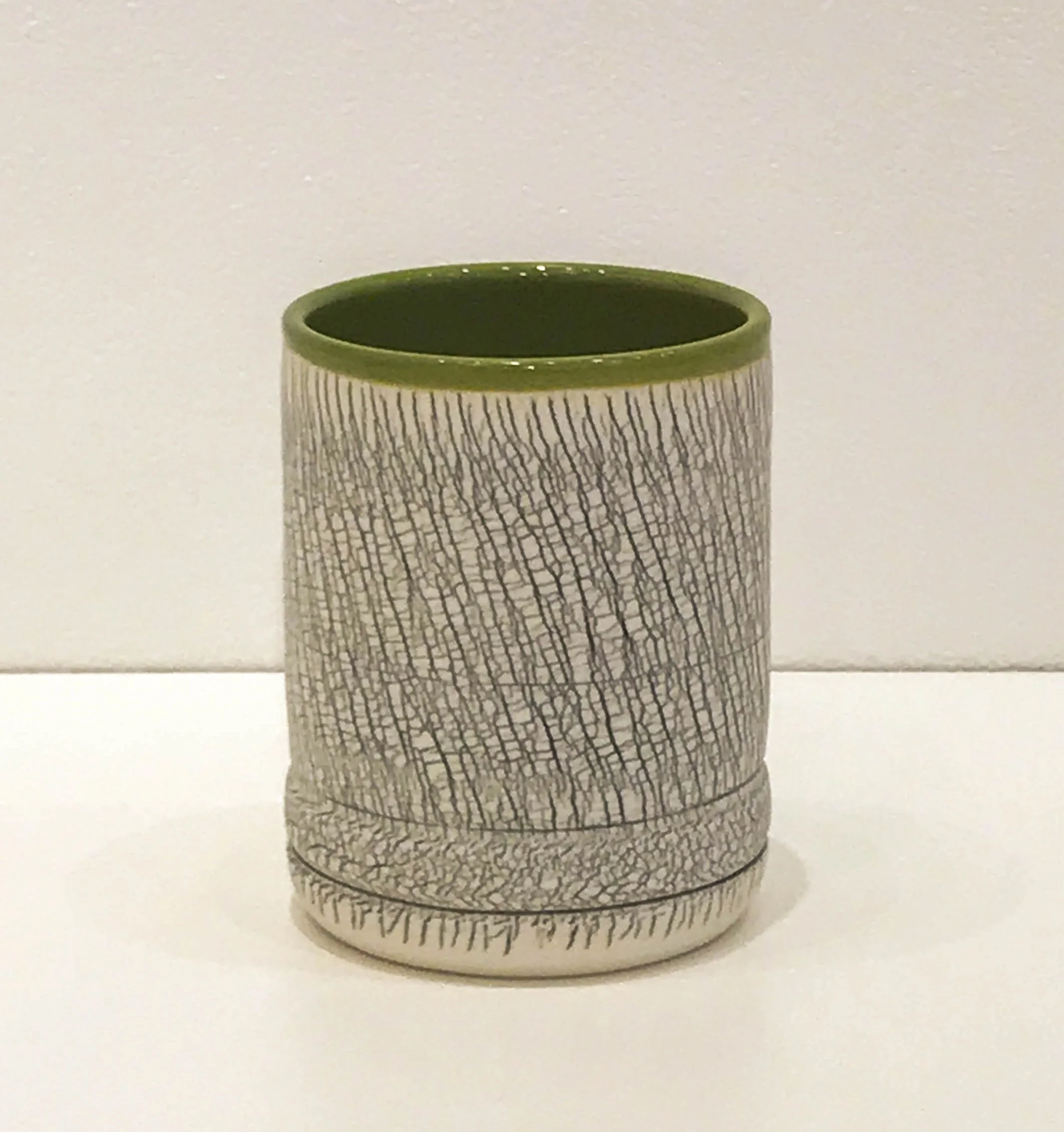 Wheel-thrown and hand-altered tumbler with black crackle and orange glazed interior, 4" x 3" x 3", $45