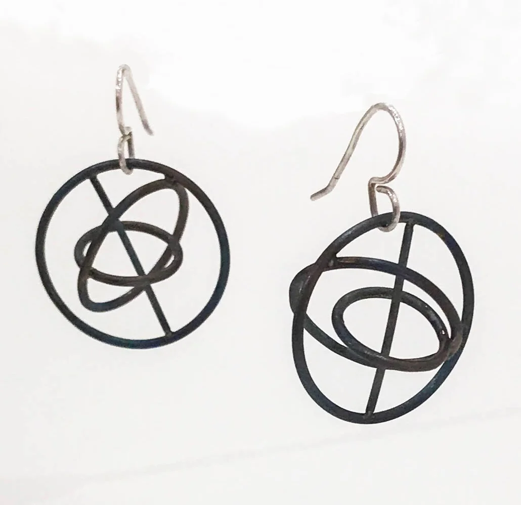 Titanium orbit earrings with silver ear wire, 1 1/2" x 1" x 1", $90