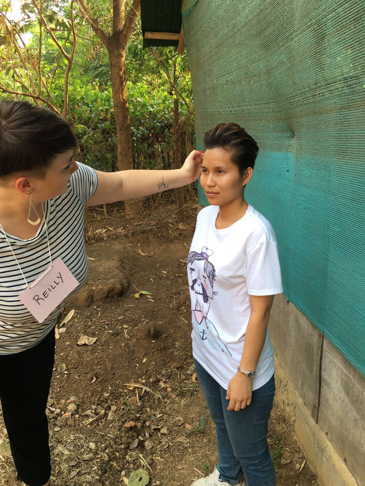 Reilly from HAUS Salon South Minneapolis touches up Phadkaew for her "after" photo.