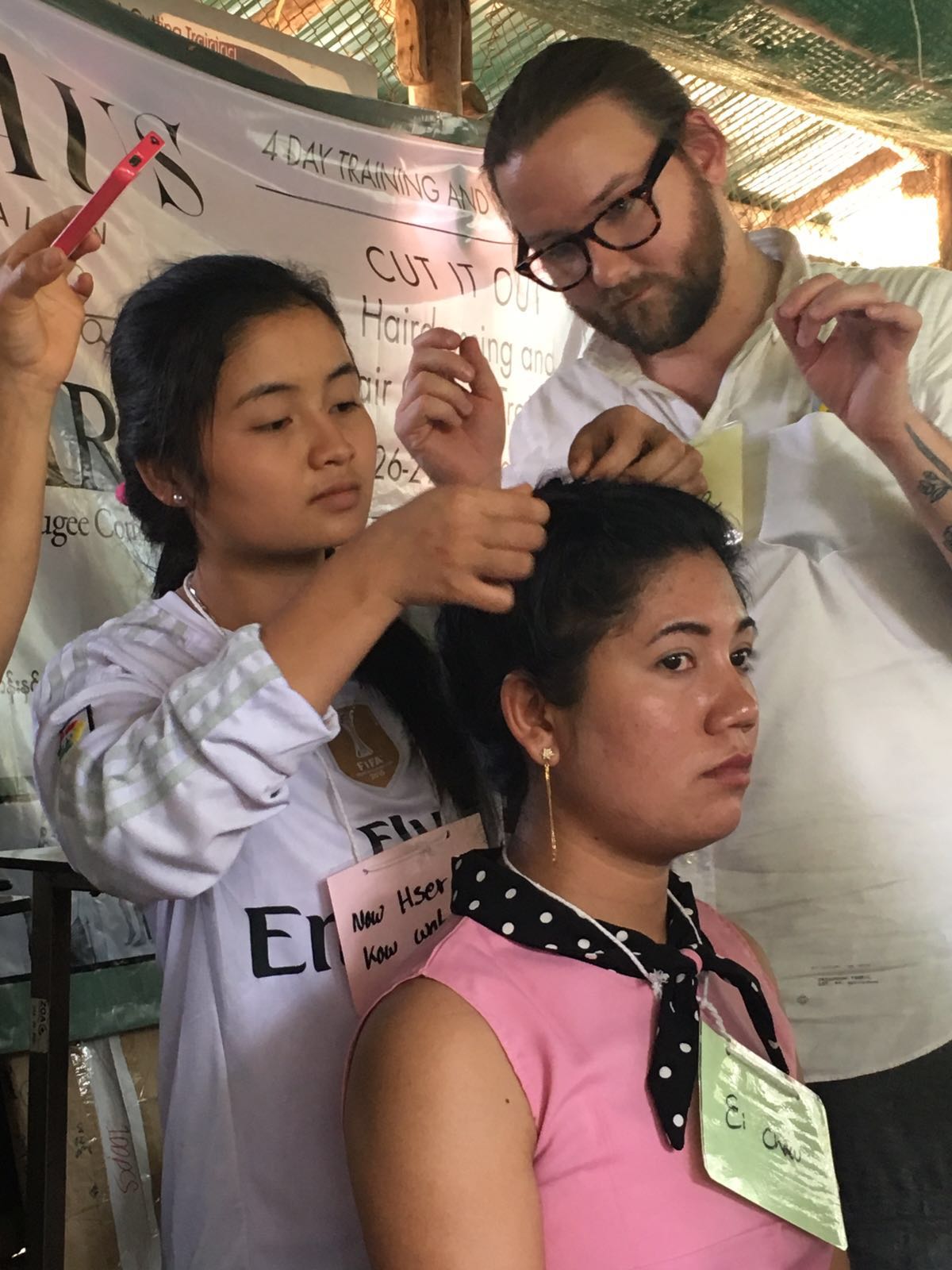 Naw Hser Ka Wah learning braiding and up styling techniques from Charlie.