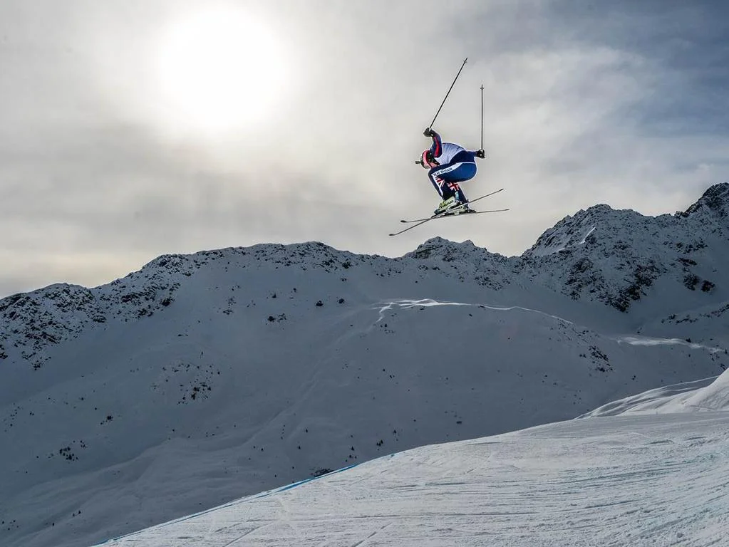 Aiglon alumna Liz Stevenson on the slopes... or several feet over the slopes. She placed 19th in the World Cup ski cross standings this past season. ©GEPA