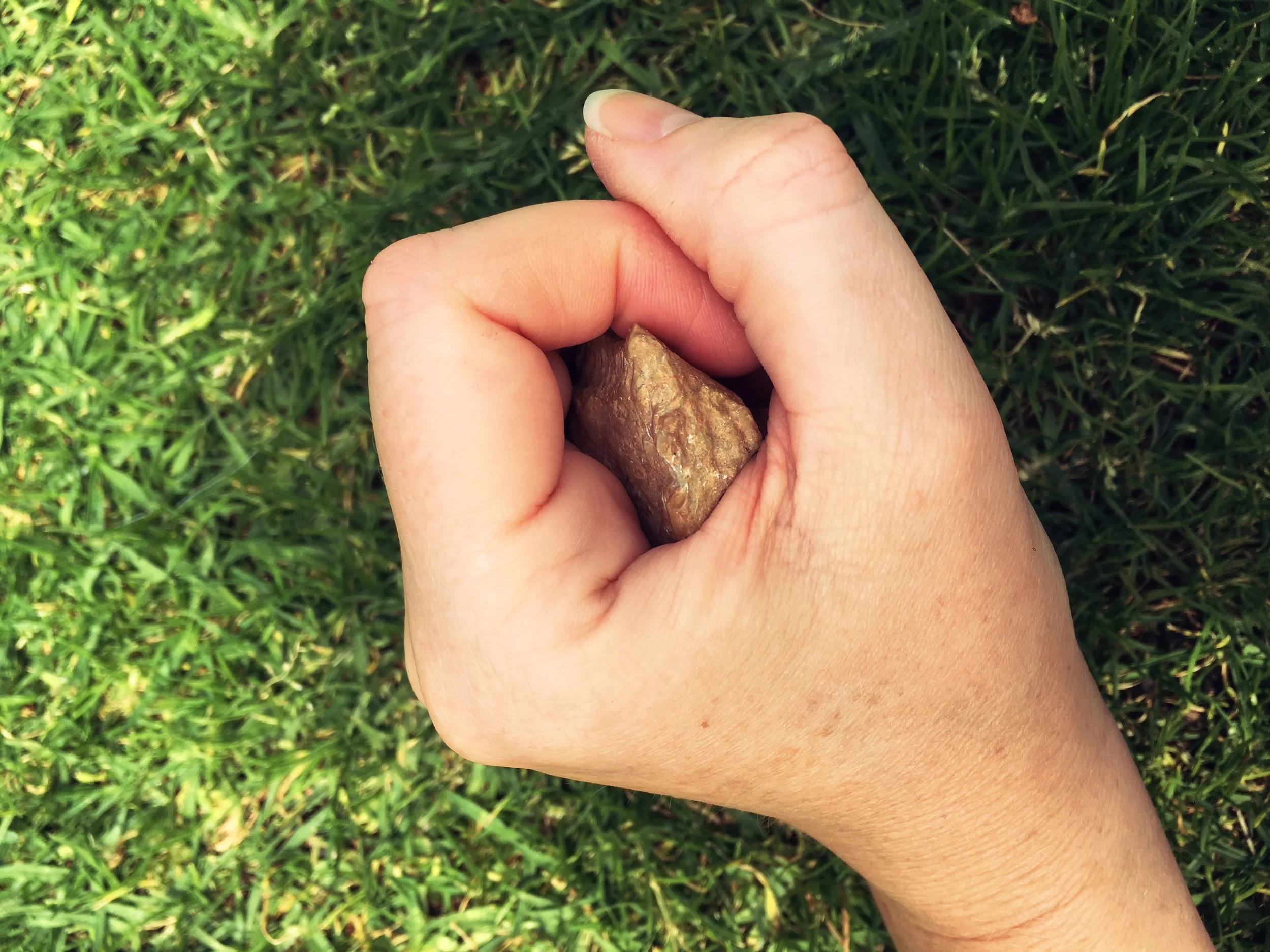 HOLDING AND BLOWING INTO A MEDICINE STONE