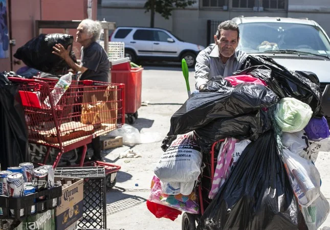  A man pushes his cart of cans to the Sure We Can redemption center in Brooklyn. (Samira Bouaou/Epoch Times)  