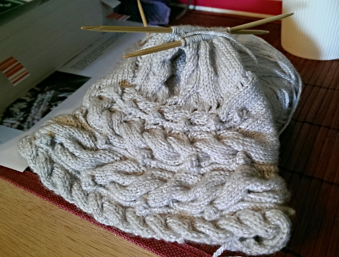 The beginning of the hood. You do need to be careful when you pick up the stitches so you distribute them evenly around the neckline. You pretty much are skipping 2-3 stitches between picked up stitches. If you picked up every stitch around, the hood would be huge!