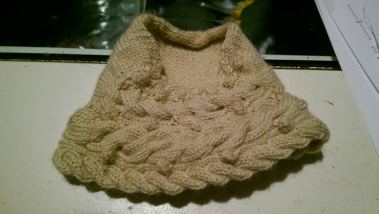 Laceweight yarn held double on size 0 US needles. The front and back is done, and seam done. 