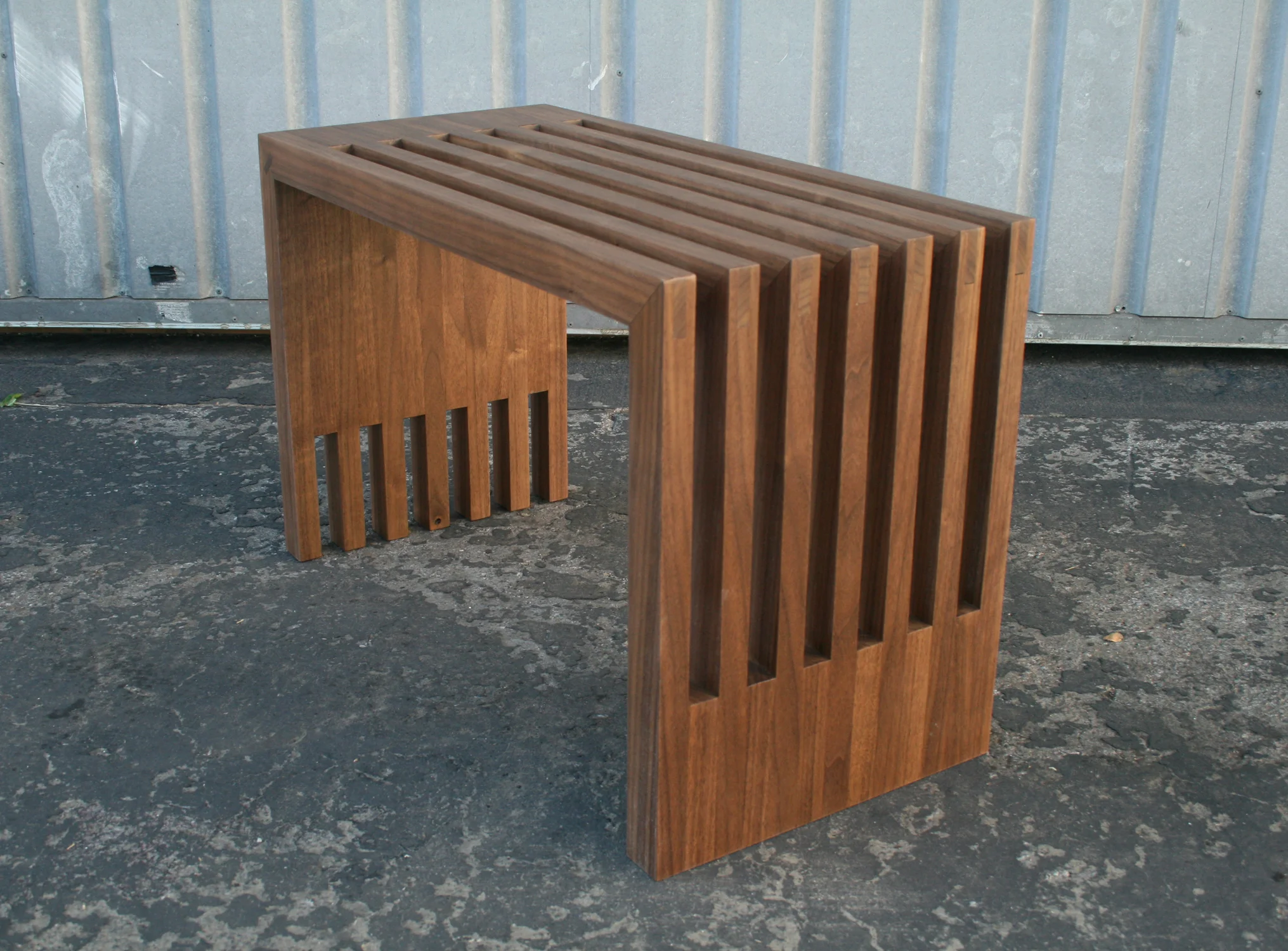   BERKELEY BENCH   Slatted bench in solid claro walnut. 