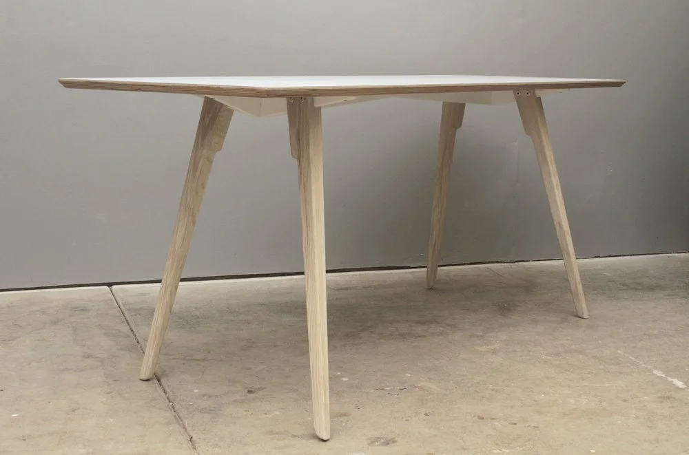  Work station with bleached oak legs, a powder coated aluminum chassis, and a Formica top. 