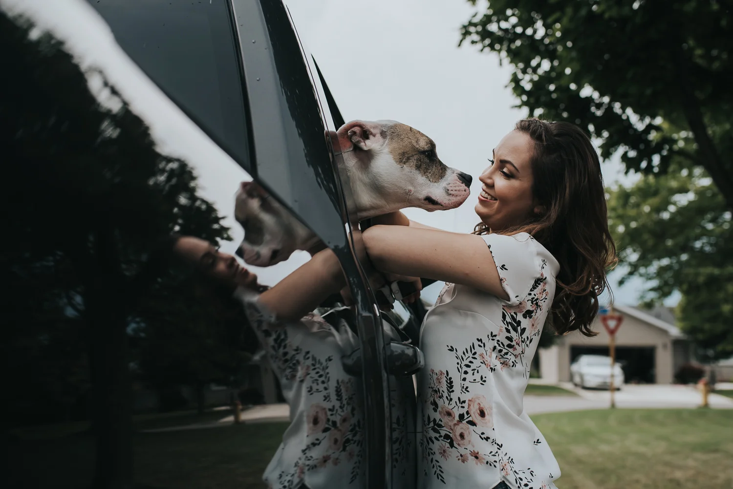 Bride being greeted by her dog out of black truck window
