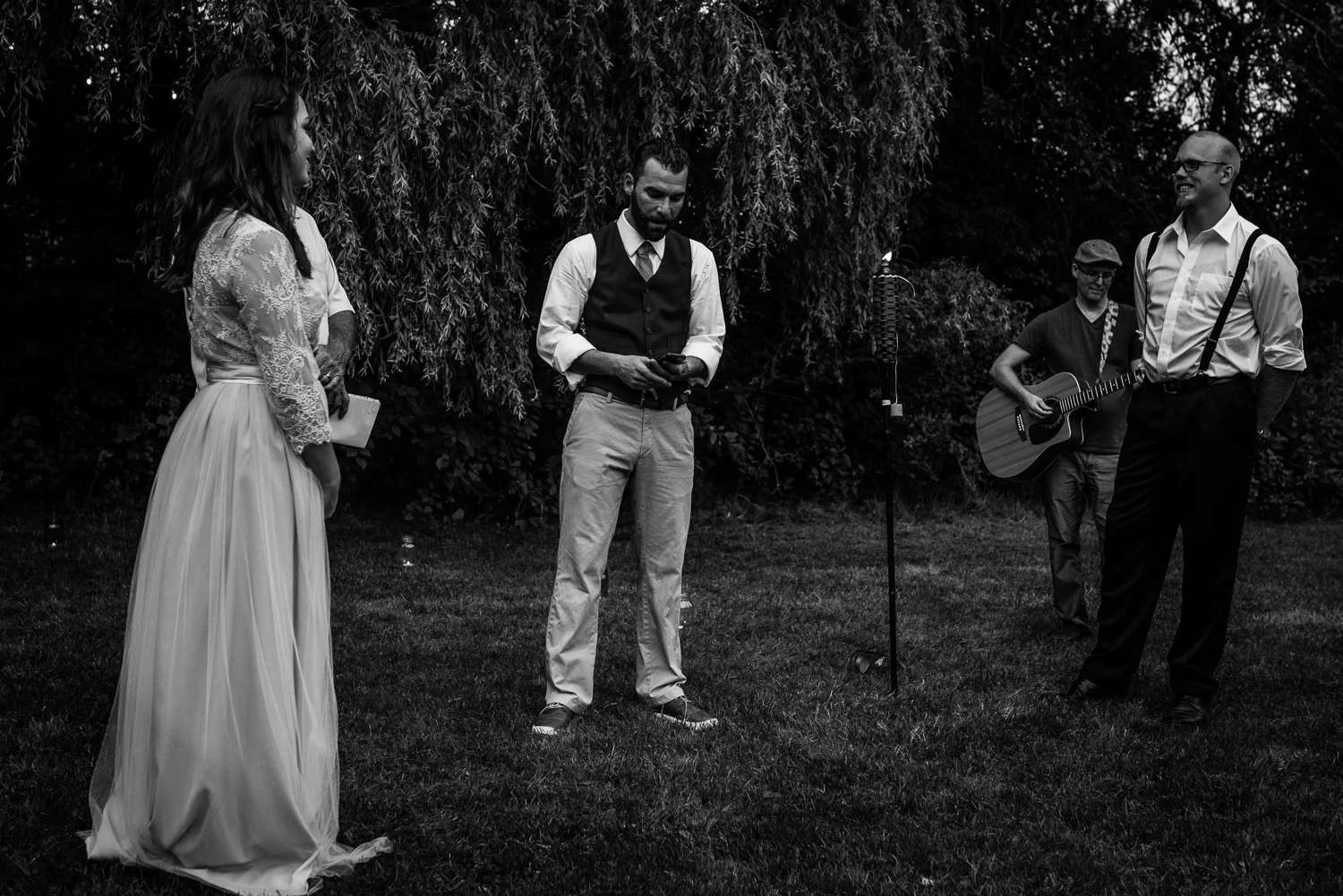 Groom serenading his wife while his brother plays guitar
