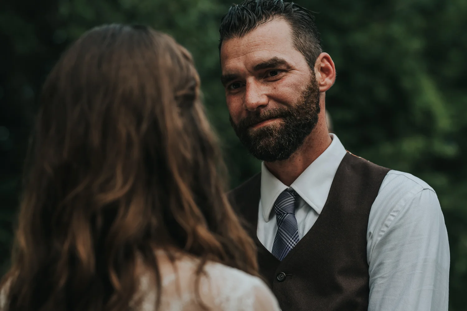 Groom looking lovingly at his soon to be wife